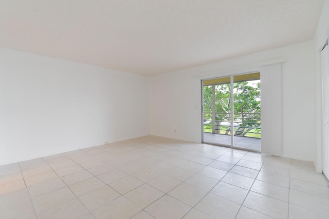 tiled spare room with a textured ceiling