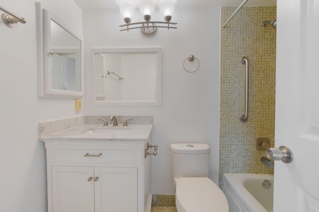 full bathroom with tiled shower / bath, vanity, and toilet