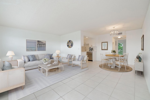 tiled living room featuring an inviting chandelier