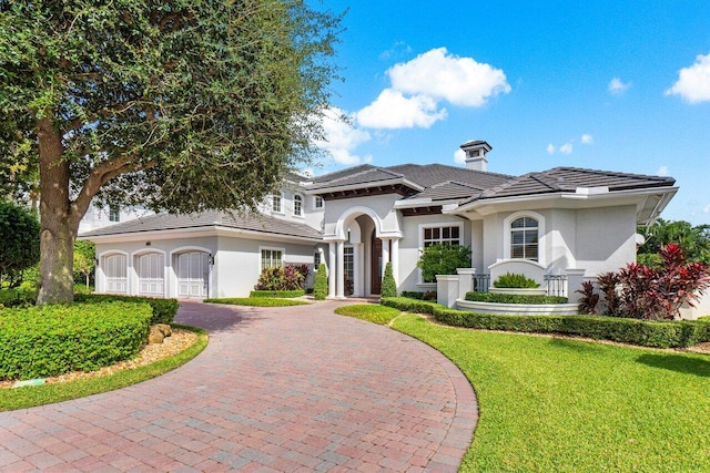 mediterranean / spanish house with a front lawn