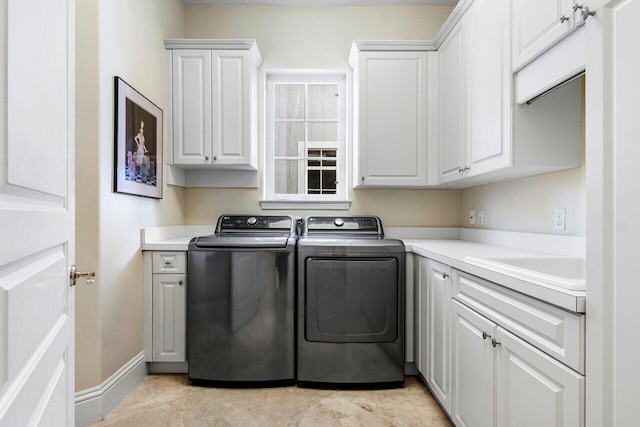 laundry room featuring cabinets, independent washer and dryer, and light tile patterned flooring