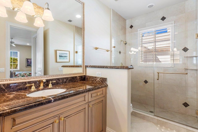 bathroom featuring toilet, tile patterned floors, vanity, ceiling fan, and walk in shower