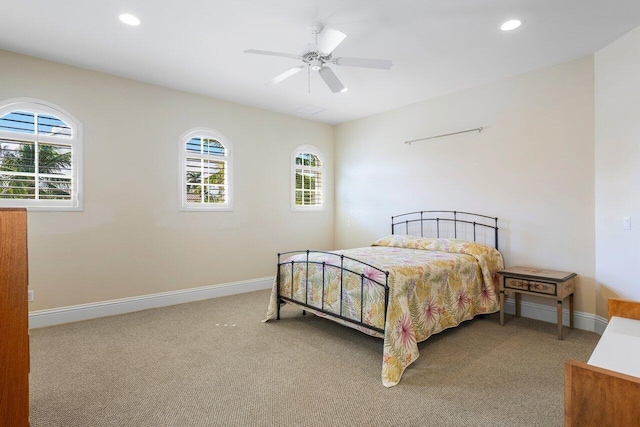 bedroom featuring carpet flooring, multiple windows, and ceiling fan