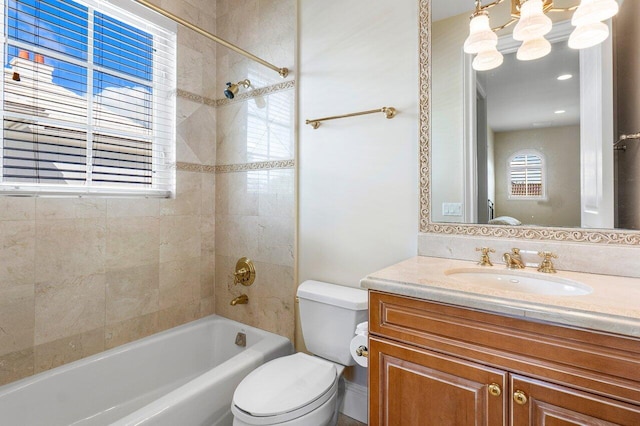 full bathroom with vanity, toilet, and tiled shower / bath combo