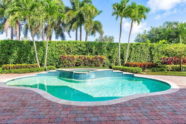 view of swimming pool featuring an in ground hot tub