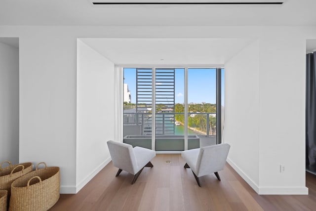 living area with hardwood / wood-style flooring