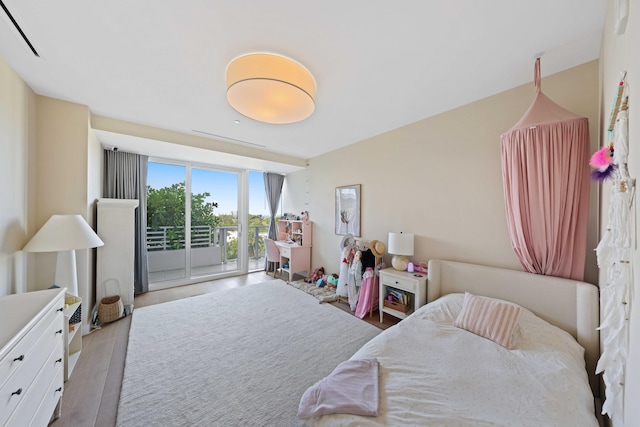 bedroom with access to outside and light hardwood / wood-style floors