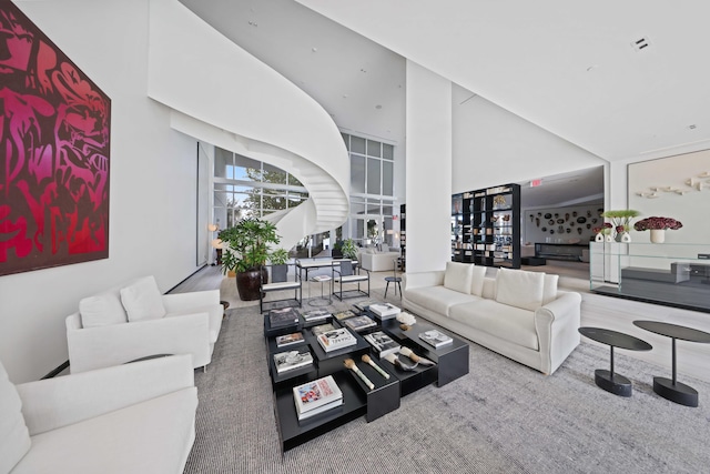 living room featuring a high ceiling and carpet floors