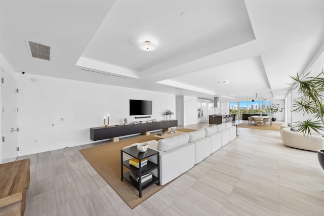 living room featuring a tray ceiling