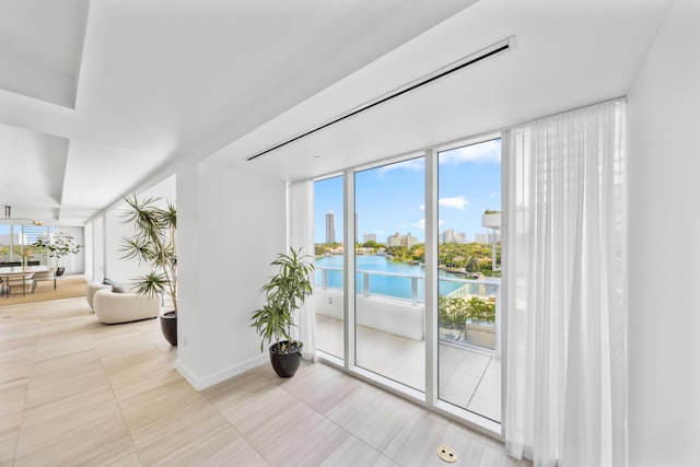 interior space with a water view and light tile patterned flooring