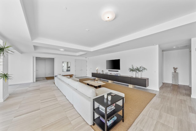 living room with a tray ceiling