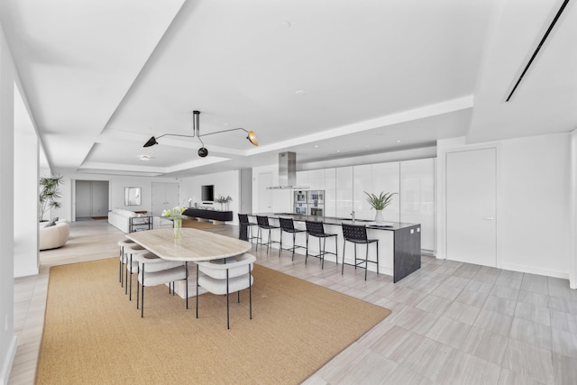 dining area with a raised ceiling