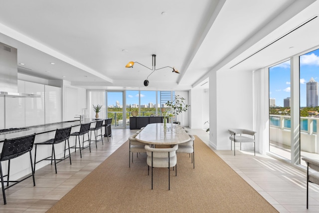 dining area featuring light tile patterned floors and a notable chandelier