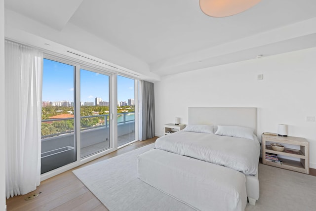 bedroom with access to exterior and light hardwood / wood-style flooring