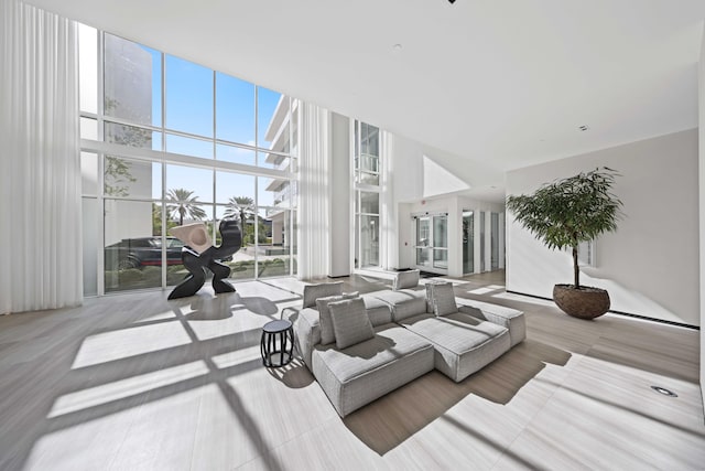 living room featuring expansive windows and a high ceiling