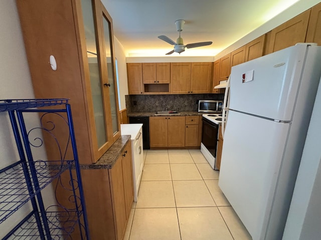 kitchen with tasteful backsplash, light tile patterned floors, sink, white appliances, and ceiling fan