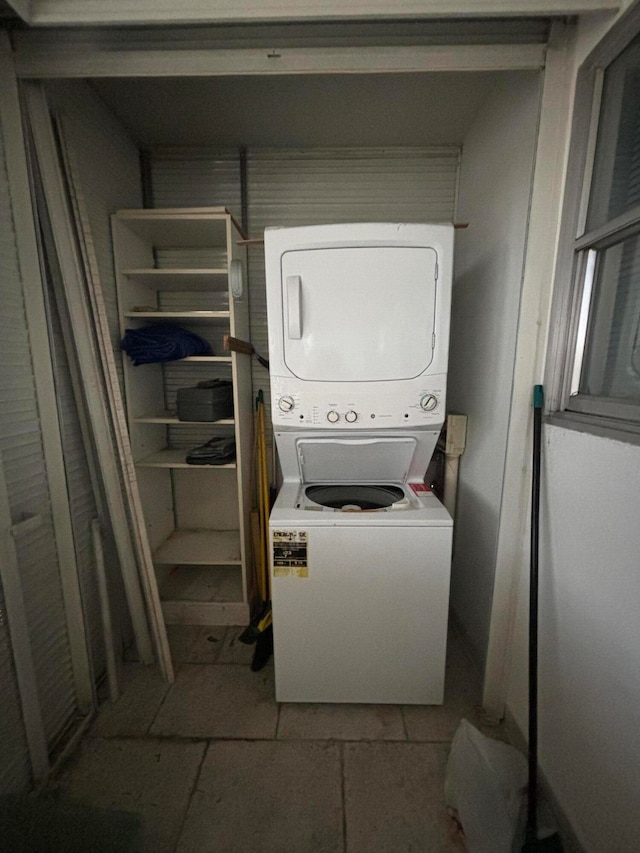 laundry area with stacked washer and dryer