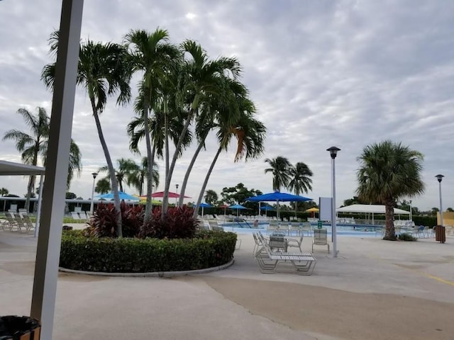 view of property's community featuring a swimming pool and a patio