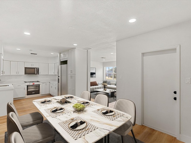 dining area with light wood-type flooring