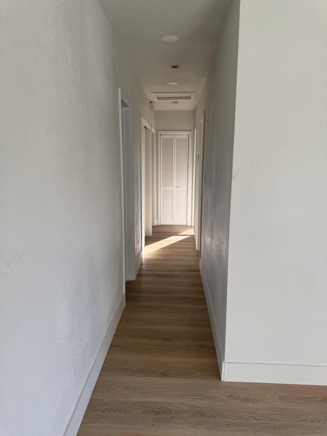 corridor featuring dark hardwood / wood-style floors