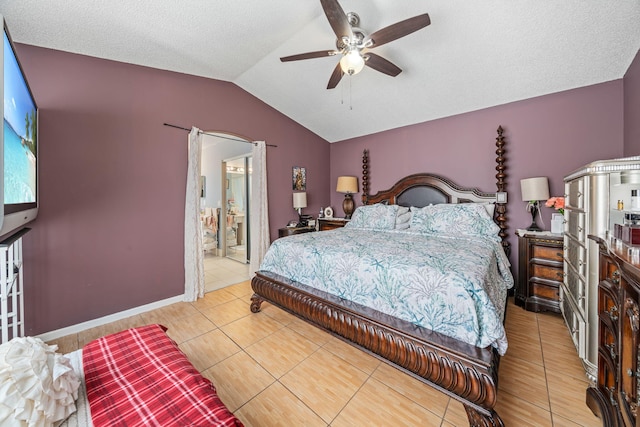 bedroom with ceiling fan, tile patterned floors, a textured ceiling, and lofted ceiling