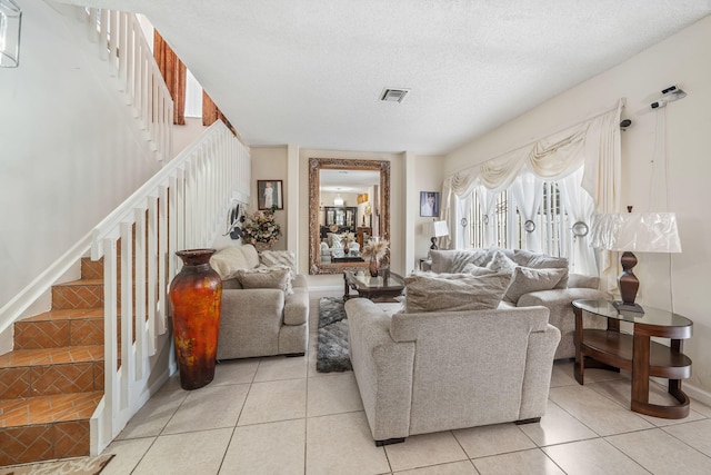 living room featuring a textured ceiling and light tile patterned flooring