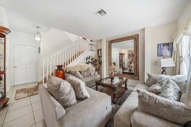 tiled living room featuring a textured ceiling