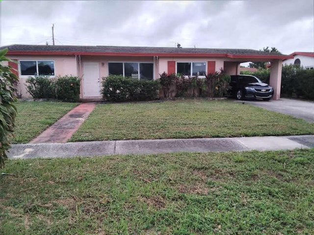 ranch-style home with a front yard and a carport