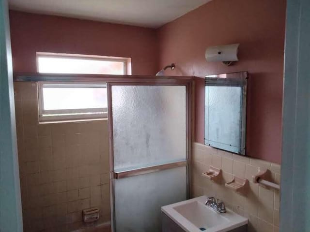 bathroom featuring tile walls and sink