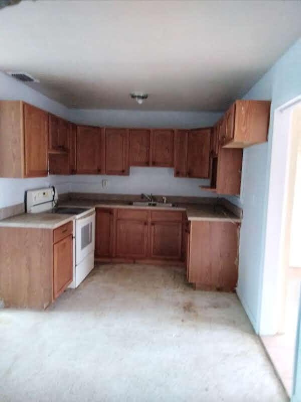 kitchen featuring sink and white electric range