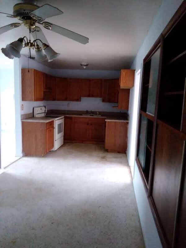 kitchen with sink, white electric range oven, and ceiling fan