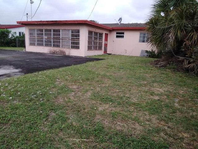 rear view of house with a patio area and a yard