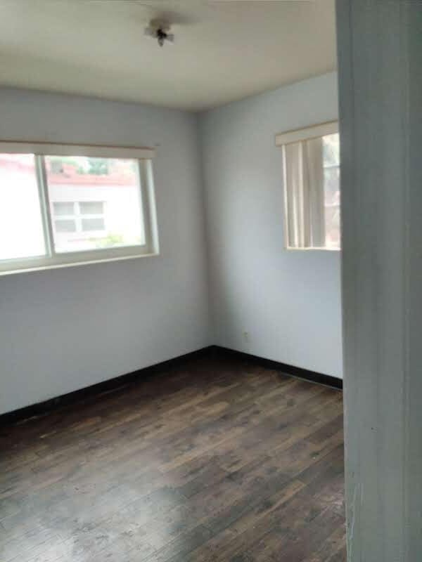 unfurnished room featuring dark hardwood / wood-style flooring