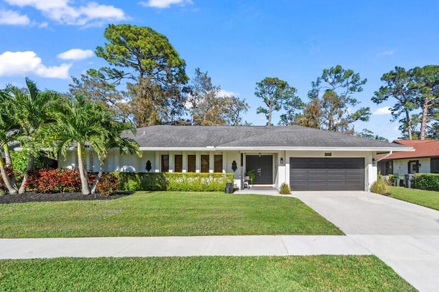 ranch-style house featuring a garage and a front lawn