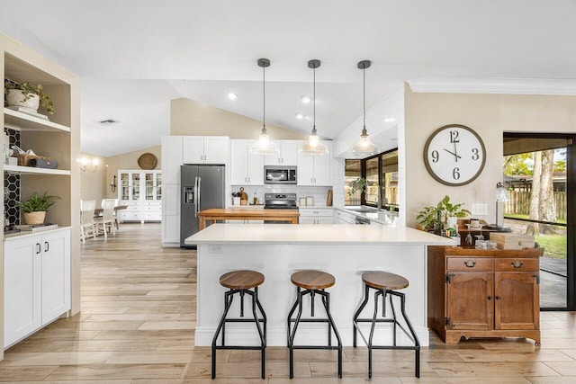 kitchen with plenty of natural light, white cabinetry, and appliances with stainless steel finishes