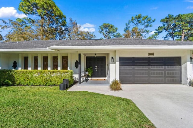 single story home with a porch, a garage, and a front lawn