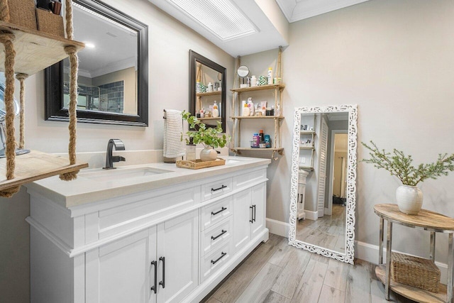 bathroom featuring hardwood / wood-style flooring, vanity, and crown molding