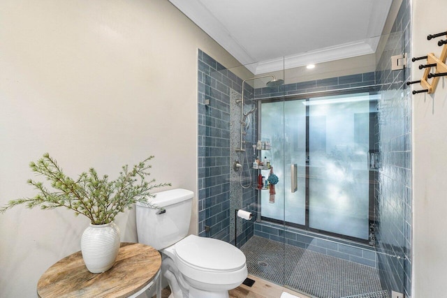 bathroom featuring crown molding, wood-type flooring, an enclosed shower, and toilet