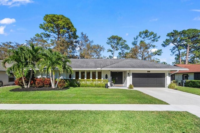 ranch-style home with a garage and a front lawn