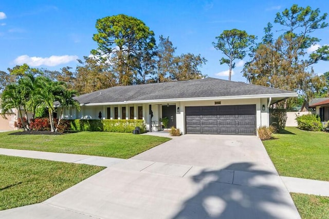 ranch-style home featuring a garage and a front lawn