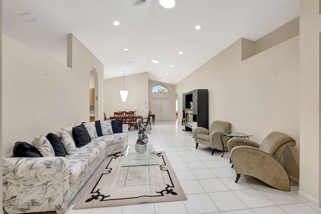 tiled living room with high vaulted ceiling