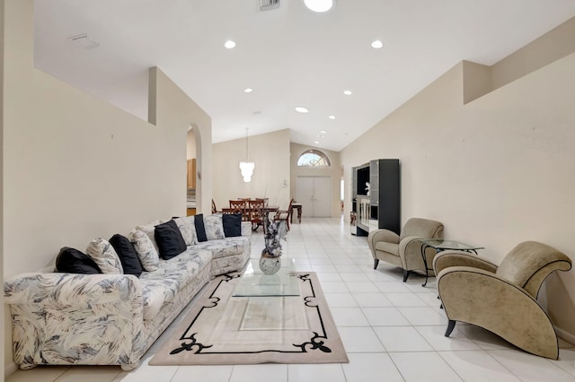 living room featuring high vaulted ceiling and light tile patterned flooring