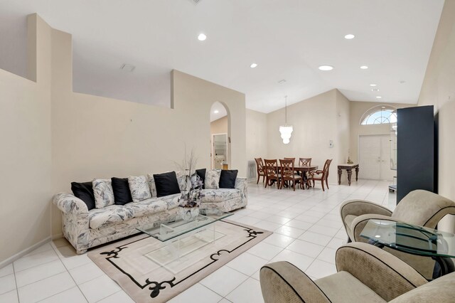 living room with light tile patterned flooring and lofted ceiling