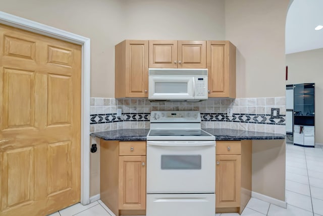 kitchen with light tile patterned floors, light brown cabinetry, and white appliances