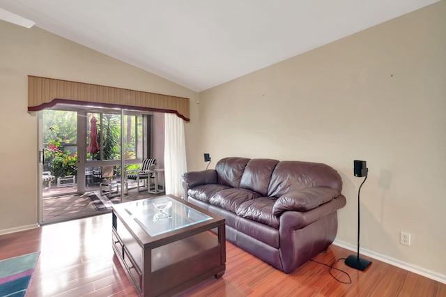 living room featuring lofted ceiling and light wood-type flooring