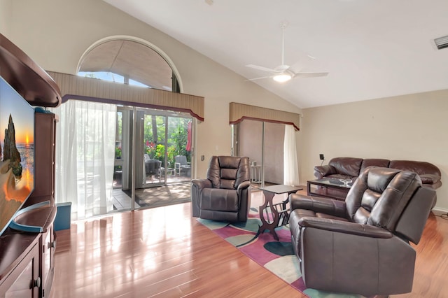 living room featuring high vaulted ceiling, ceiling fan, and light hardwood / wood-style floors