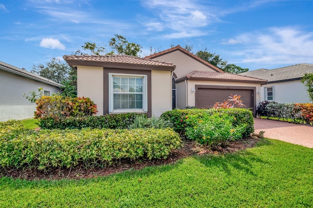 view of front of property featuring a garage and a front lawn