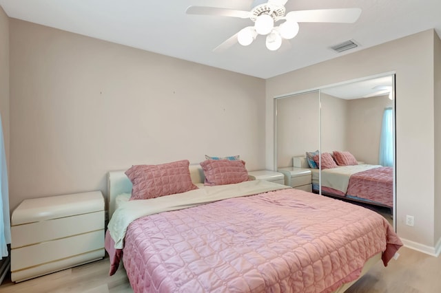 bedroom featuring a closet, light hardwood / wood-style floors, and ceiling fan