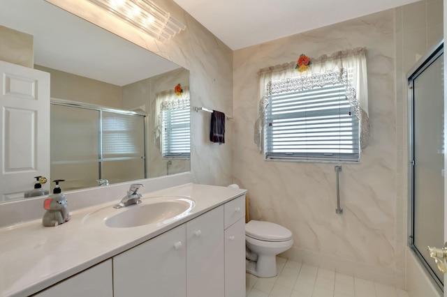 bathroom with toilet, vanity, and tile patterned floors