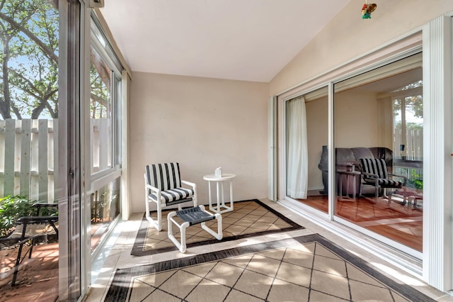 sunroom featuring vaulted ceiling